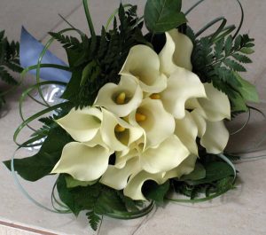 Hand tied wedding bouquet with white calla lilies and fern