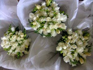 Natural hand tied wedding bouquet with cream roses and cream freesias and camellia leaves
